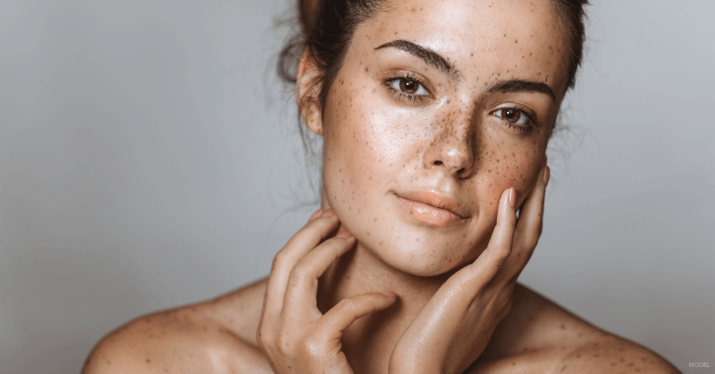 Attractive young woman with beautiful skin seen from bare shoulders up